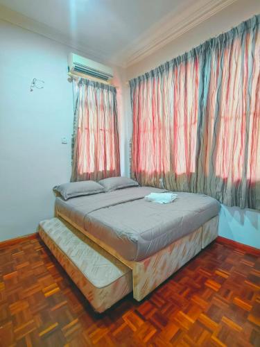 a bedroom with two beds and a window at AaronL Homestay in Kota Kinabalu