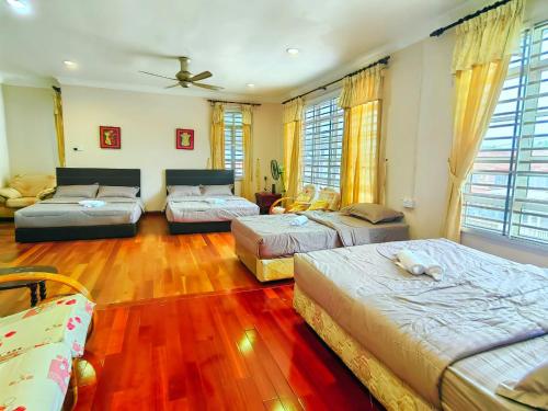 a living room with three beds and a couch at AaronL Homestay in Kota Kinabalu
