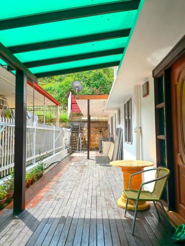 a patio with a table and chairs on a deck at AaronL Homestay in Kota Kinabalu
