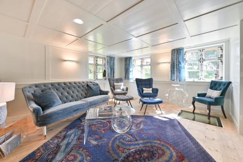 a living room with a couch and two chairs at Voglen 2 in Nesselwang