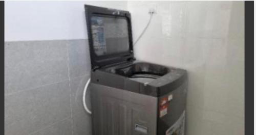 a video game machine in a corner of a room at Araas Boutique House for Family Stay ONLY in Sungai Buluh