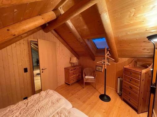 Dormitorio con cama y escritorio en una cabaña en Ferienhaus "Bella Vista" in Lottigna mit grossem Umschwung, Pergola, Grill und Pizzaofen en Lottigna