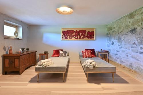 a room with two beds and a table and a wall at Voglen 2 in Nesselwang