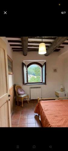 a bedroom with a bed and a window at Castelvecchio 168 in Sarnano