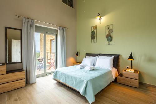 a bedroom with a bed and a large window at Entheon Olive Villas - Poolside Retreats in Marathopoli
