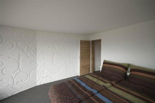 Giường trong phòng chung tại Hoegerli Alpenblick