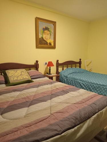 a bedroom with two beds and a picture on the wall at Lo de franco in Salta