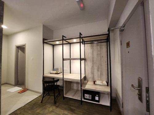 a room with a closet with a table and a chair at Perkasa Hotel Mt Kinabalu in Kundasang