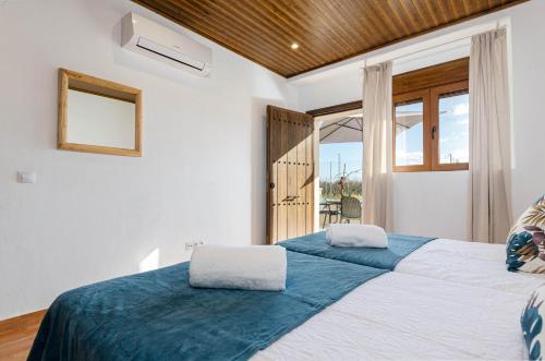 a bedroom with two beds and a large window at Agroturismo El Limonar 3, YourHouse in Inca