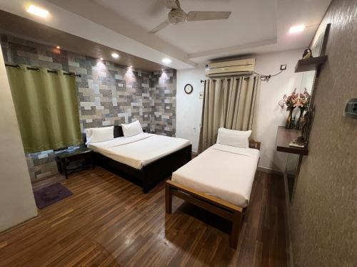 a room with two beds in a room at Vishranthi Home Stay in Chennai