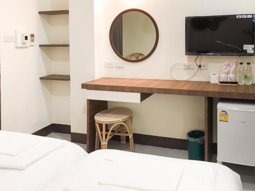 Postel nebo postele na pokoji v ubytování บ้านสวนอินทาวน์ Baansuan in Town Hotel