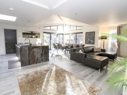 a living room with a couch and a table at Heilan Roo in Pitlochry