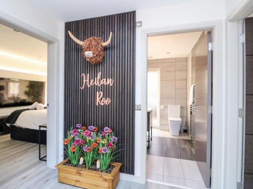 a door to a bedroom with a bull head on the wall at Heilan Roo in Pitlochry