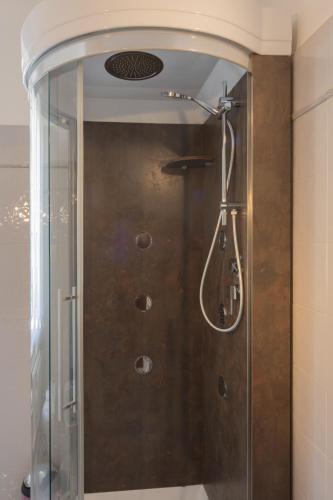 a shower with a glass door in a bathroom at Casa Emi in Lezzeno
