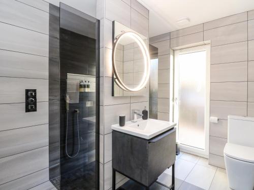 a bathroom with a sink and a shower at Heilan Roo in Pitlochry