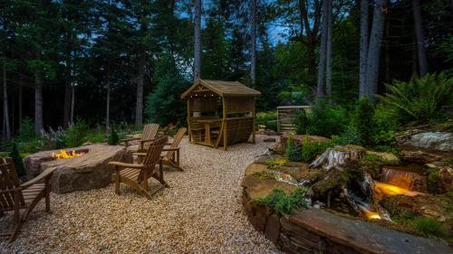 a backyard with a gazebo and a fire pit at Heilan Roo in Pitlochry