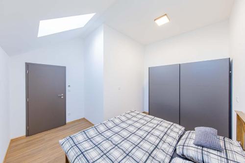 a bedroom with a bed and two closets at Rezidence Novosadská in Olomouc