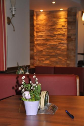 a vase of flowers sitting on a table at Gasthof zur Linde in St. Andrä am Zicksee