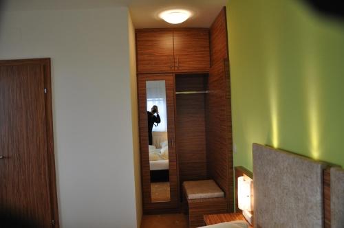 a room with a hallway with a bedroom and a mirror at Gasthof zur Linde in St. Andrä am Zicksee