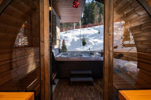 a bathroom with a sink in a cabin with snow at Musala Hotel in Borovets