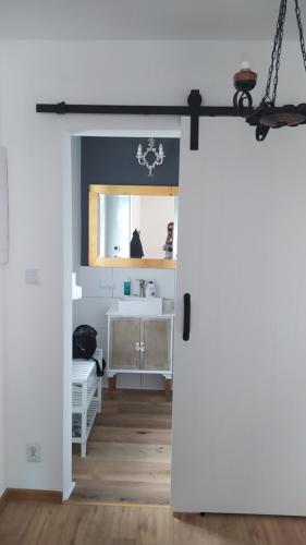 a door leading into a bathroom with a sink at Całkiem Klawa Enklawa in Brzozie