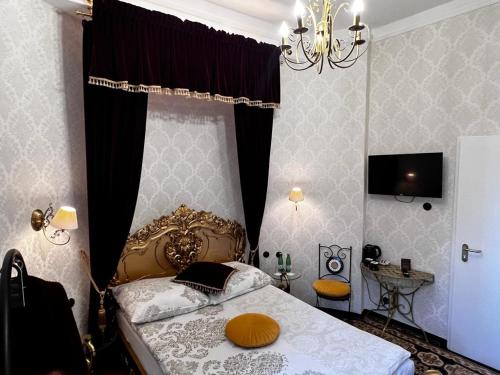 a bedroom with a bed and a chandelier at Night o'clock Business and Spa Aparts in Opole