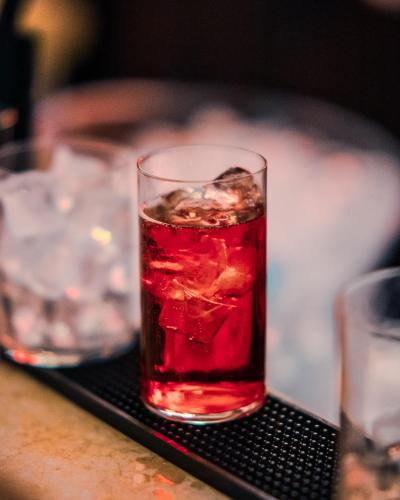 a drink in a glass sitting on a table at Panoramic Rooms Torre della Vittoria in Ferrara