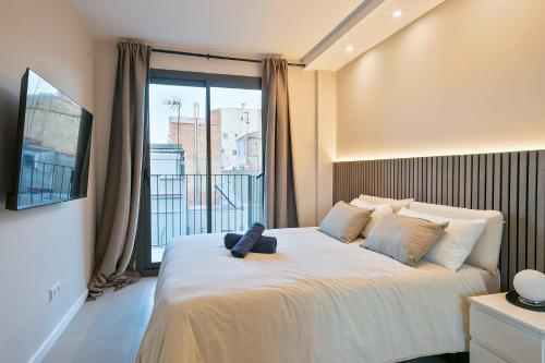 a bedroom with a bed with a teddy bear on it at YOUR HOME- Apartment Camp Nou 2b in Hospitalet de Llobregat