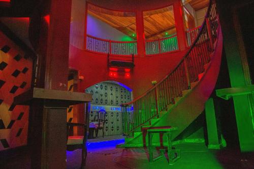 a room with a staircase with red and green lights at The Keza Hotel and Apartments in Kigali