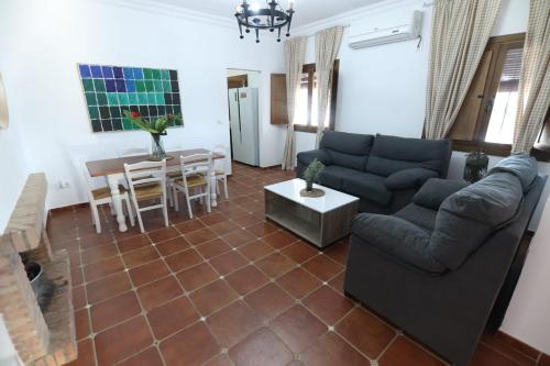 a living room with a couch and a table at Villa Romero in Mairena del Alcor