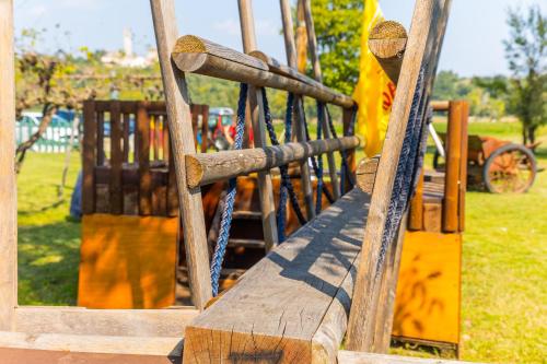 a wooden slide in a park with a playground at AGRITURISMO RIVA RATTA in Montecchio Maggiore