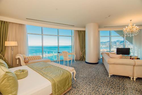 a hotel room with a bed and a couch at JRW Welmond Hotel in Batumi