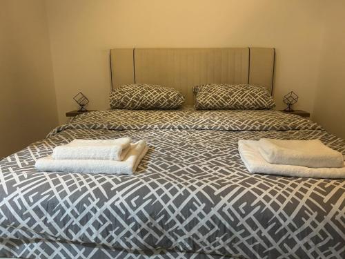 a bedroom with a bed with two pillows on it at Apartment Sun & Moon in Sarajevo