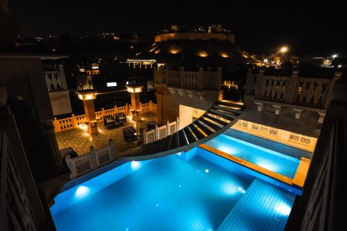 a view of a swimming pool at night at Guulab Haveli in Jaisalmer