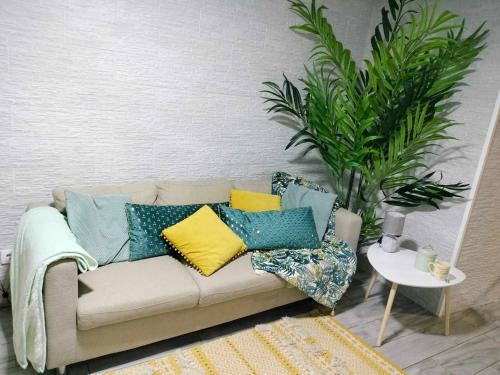 a couch with colorful pillows in a living room at Casa Corpo Santo in Vila Franca do Campo