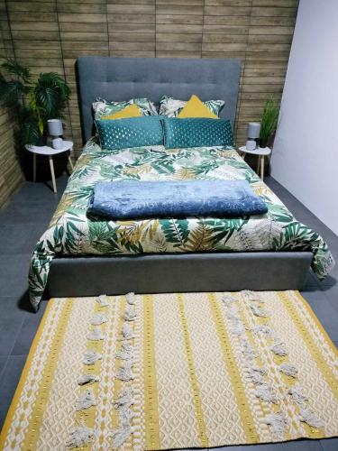 a bedroom with a bed with a blue head board at Casa Corpo Santo in Vila Franca do Campo
