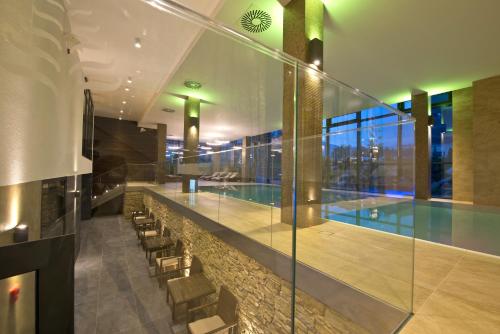 
a large swimming pool in a hotel lobby at Hotel Lesna – Adult Friendly in Stará Lesná
