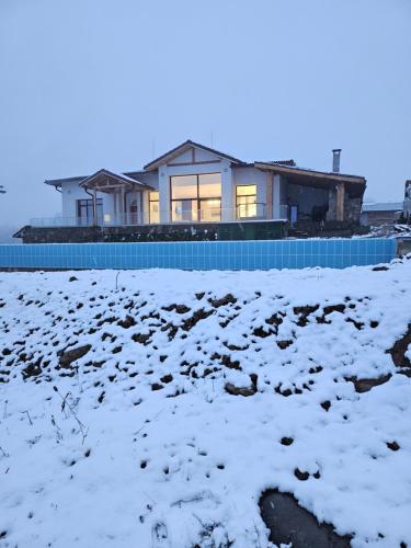 a house in the snow with a pool at Къщата на Mечтите / House of the Dreams in Apriltsi