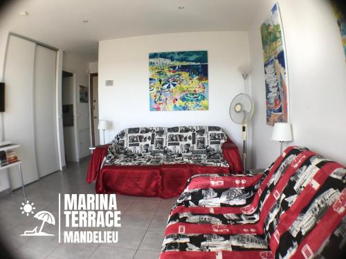 a living room with a bed and a couch at Marina Terrace in Mandelieu-la-Napoule