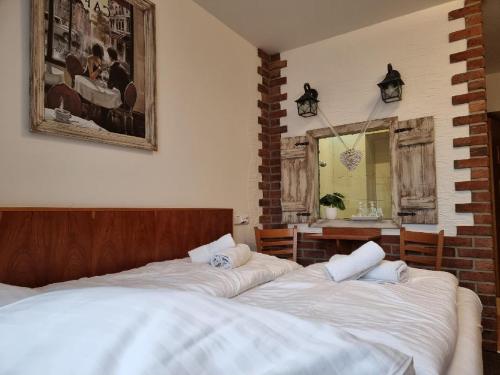 a bedroom with two beds and a mirror in it at Hotel Panský dům in Blovice