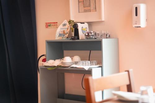 a table with plates and glasses on a shelf at NorthSpot in Nazaré