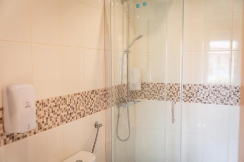 a bathroom with a shower and a toilet at NorthSpot in Nazaré
