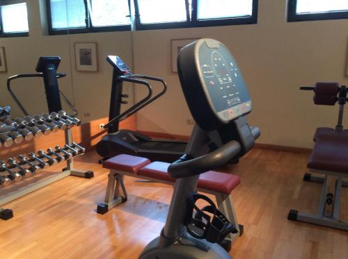 a gym with several treadmills and a treadmill at Meridiana Country Hotel in Calenzano