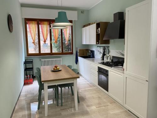 a kitchen with a table with a plate of fruit on it at Via Verdi 14 in Mondolfo