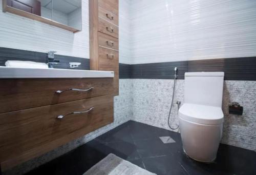 a bathroom with a toilet and a sink at Modern Studio In Resortz Residence - Arjan in Dubai