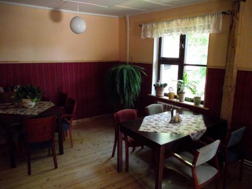 a dining room with tables and chairs and a window at Paide B&B in Paide