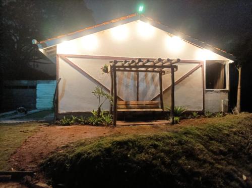 a small white house with lights on it at night at Sítio Werly in Domingos Martins