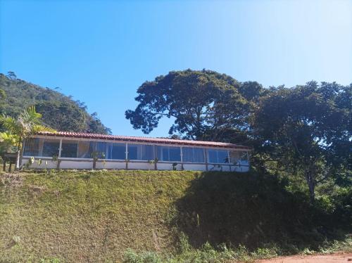 a train on top of a hill with trees at Sítio Werly in Domingos Martins