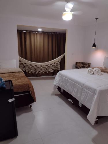 a bedroom with a bed and a hammock in it at Sítio Werly in Domingos Martins