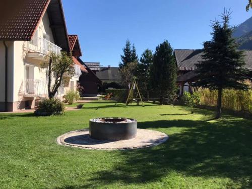 a fire pit in the middle of a yard at Apartmaji Misotič in Gozd Martuljek